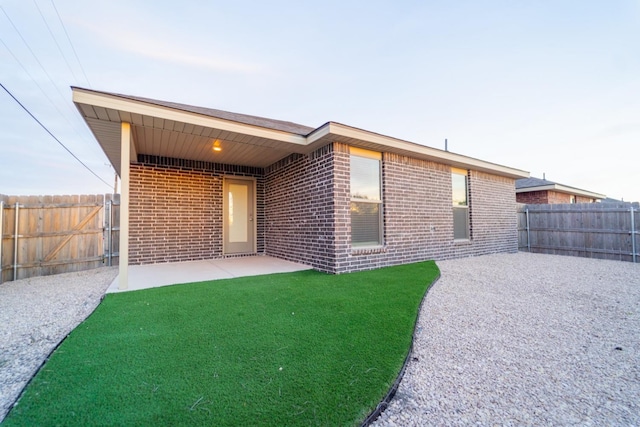 back of house featuring a yard and a patio area