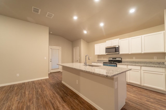 kitchen with stainless steel appliances, light stone countertops, sink, and a kitchen island with sink