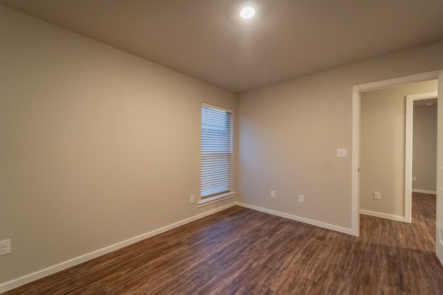 empty room featuring dark hardwood / wood-style flooring