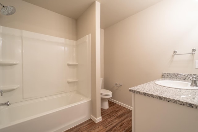 full bathroom featuring vanity, hardwood / wood-style flooring, shower / bathtub combination, and toilet