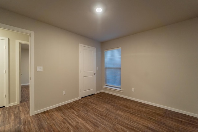 spare room featuring dark hardwood / wood-style floors