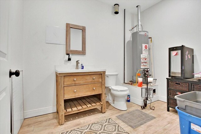 full bathroom featuring vanity, hardwood / wood-style flooring, gas water heater, and bathtub / shower combination