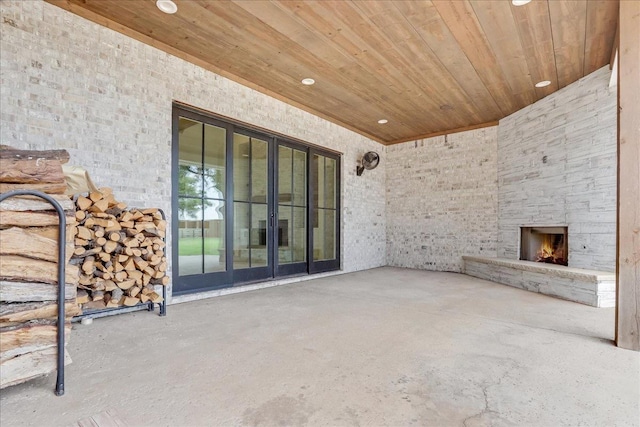 view of patio featuring an outdoor stone fireplace