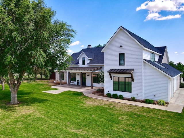 view of front of home with a patio area and a front lawn