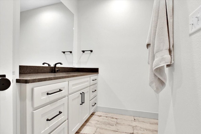 bathroom with hardwood / wood-style flooring and vanity