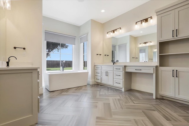 bathroom with vanity and a tub