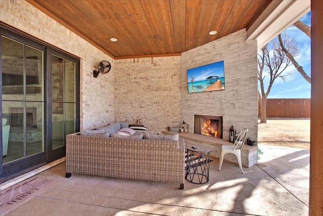 view of patio / terrace with an outdoor living space with a fireplace