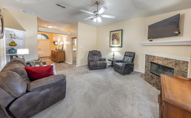 10609 Elkridge Ave, Lubbock, TX 79423 - carpeted living area with a fireplace, ceiling fan, lofted ceiling, and a textured ceiling