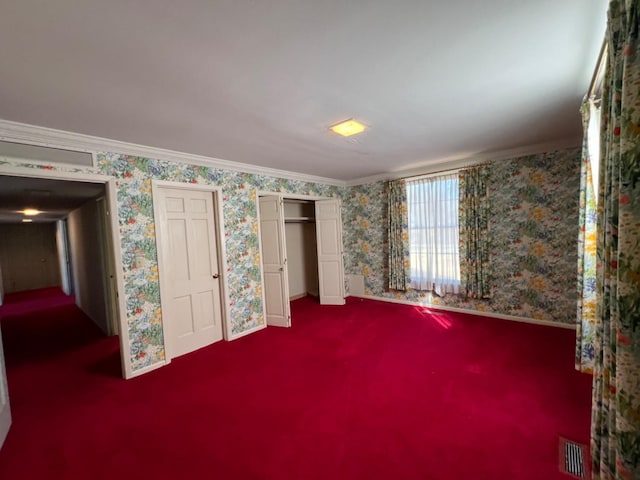 unfurnished bedroom with ornamental molding and carpet