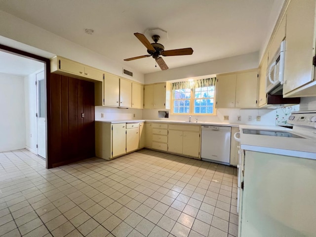 kitchen featuring ceiling fan, cream cabinets, light tile patterned flooring, and white appliances