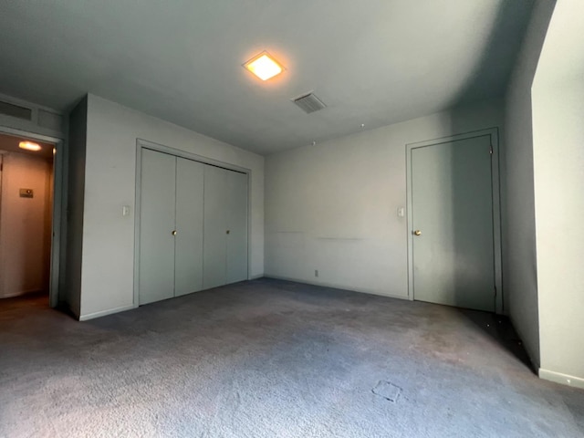 unfurnished bedroom featuring carpet and a closet