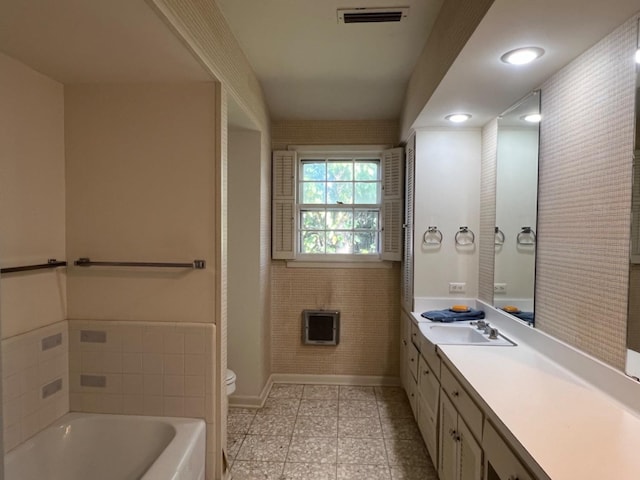 bathroom featuring vanity, toilet, and a bathtub