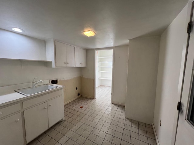 kitchen featuring white cabinetry and sink