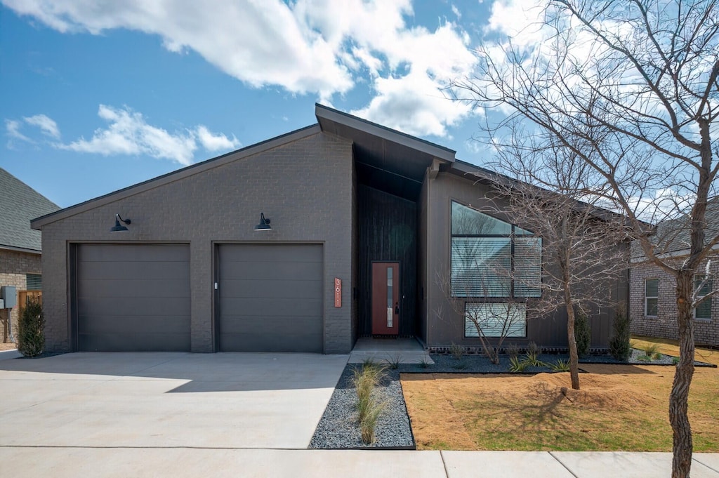 3611 122nd St, Lubbock, TX 79423 - view of front of house featuring a garage and driveway