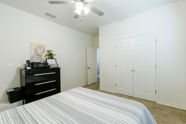 carpeted bedroom with a closet and ceiling fan