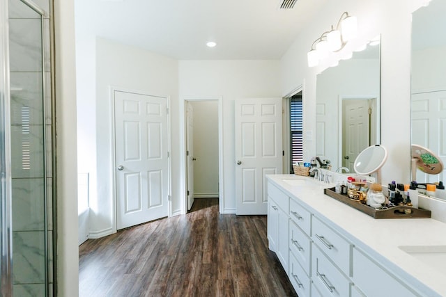 bathroom featuring vanity, hardwood / wood-style flooring, and a shower with door