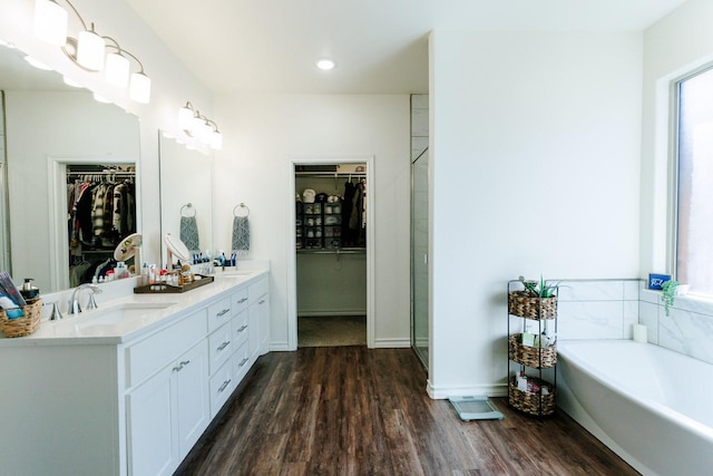 bathroom with vanity, separate shower and tub, and hardwood / wood-style floors