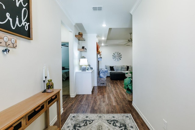 corridor featuring crown molding and dark hardwood / wood-style flooring