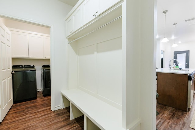 mudroom featuring dark hardwood / wood-style flooring, sink, and washer and clothes dryer