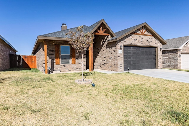 view of front of house featuring a garage and a front lawn