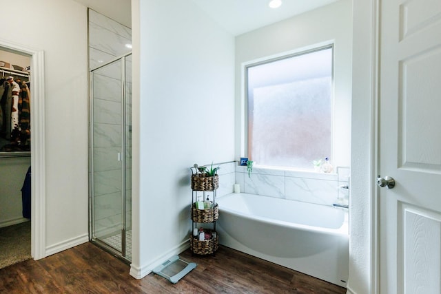 bathroom with separate shower and tub and hardwood / wood-style floors