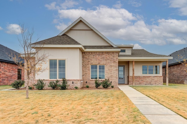 7615 52nd St, Lubbock, TX 79407 - view of front of home featuring brick siding, a front yard, and roof with shingles