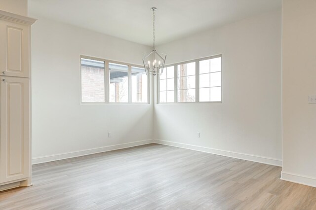 7615 52nd St, Lubbock, TX 79407 - unfurnished room featuring light wood finished floors, a chandelier, and baseboards