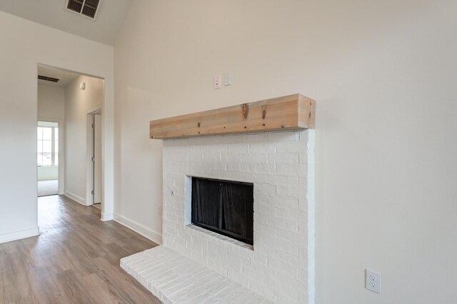 7615 52nd St, Lubbock, TX 79407 - detailed view of wood finished floors, baseboards, and a fireplace