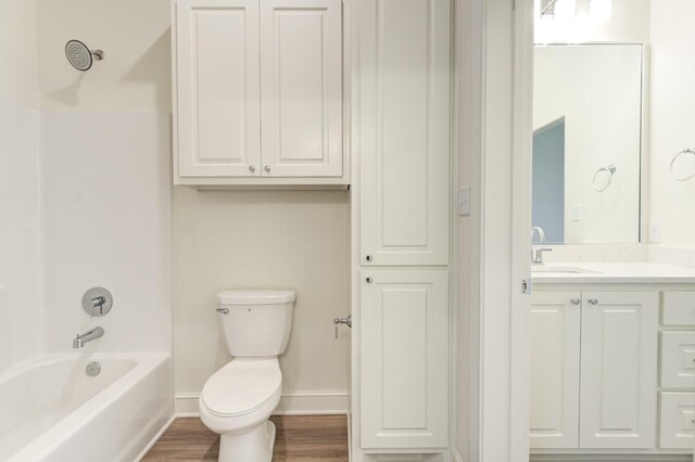 7615 52nd St, Lubbock, TX 79407 - bathroom with vanity, toilet, baseboards, shower / tub combination, and wood finished floors