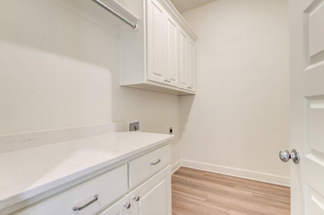 7615 52nd St, Lubbock, TX 79407 - laundry room featuring washer hookup, light wood-style flooring, hookup for an electric dryer, baseboards, and cabinet space