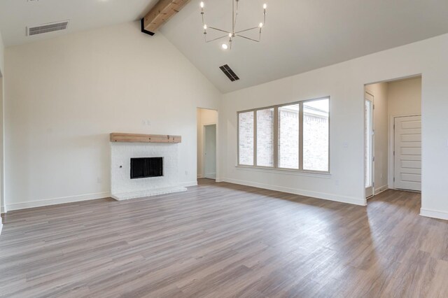 7615 52nd St, Lubbock, TX 79407 - unfurnished living room featuring beamed ceiling, a chandelier, high vaulted ceiling, wood finished floors, and baseboards