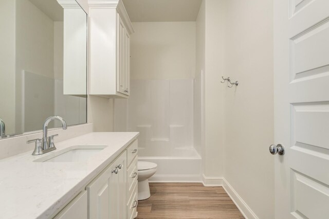 7615 52nd St, Lubbock, TX 79407 - bathroom featuring vanity, wood finished floors, toilet, baseboards, and shower / bath combination