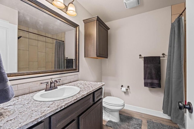 bathroom featuring vanity, toilet, and wood-type flooring