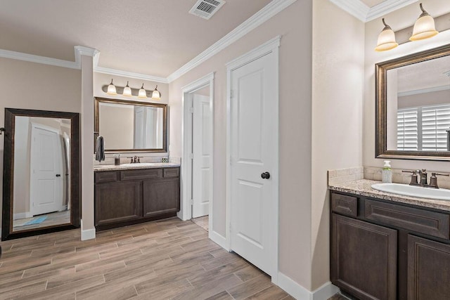 bathroom with vanity and crown molding