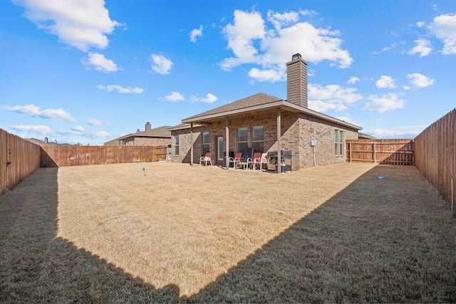 rear view of house featuring a lawn