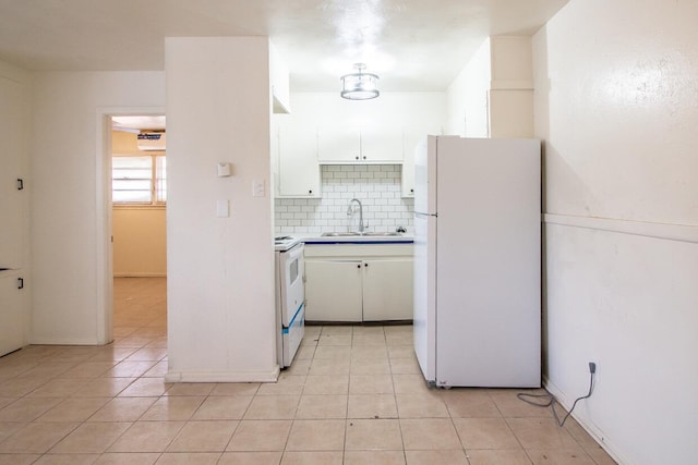 kitchen with white cabinetry, sink, decorative backsplash, light tile patterned floors, and white appliances