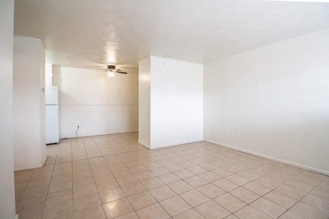 tiled empty room with ceiling fan