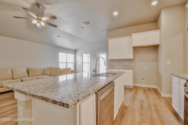 2933 Abbeville Ave, Wolfforth, TX 79382 - kitchen with dishwasher, open floor plan, a ceiling fan, vaulted ceiling, and light wood-style flooring