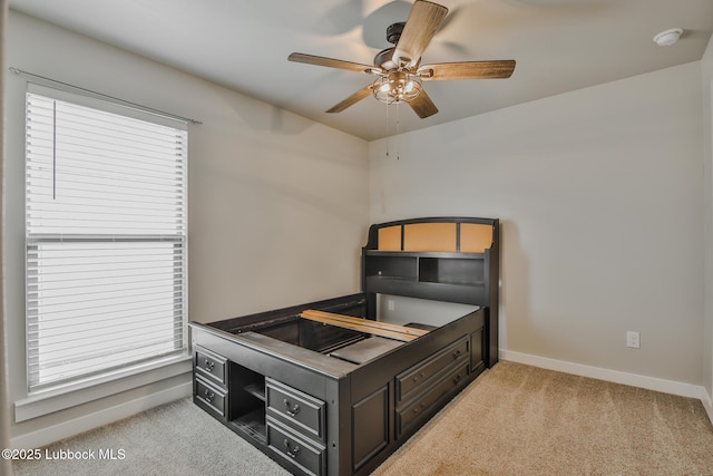 2933 Abbeville Ave, Wolfforth, TX 79382 - unfurnished bedroom featuring light colored carpet, multiple windows, and ceiling fan