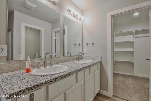 2933 Abbeville Ave, Wolfforth, TX 79382 - bathroom with double vanity and a walk in closet