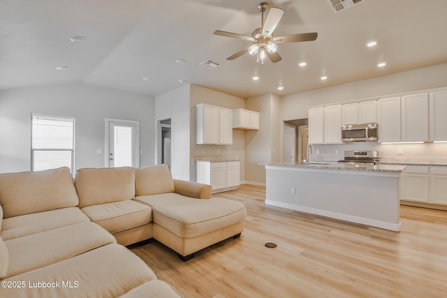 2933 Abbeville Ave, Wolfforth, TX 79382 - living room with light wood-style flooring, a ceiling fan, vaulted ceiling, and recessed lighting