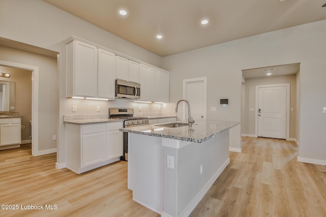 2933 Abbeville Ave, Wolfforth, TX 79382 - kitchen with appliances with stainless steel finishes, light wood finished floors, white cabinets, and recessed lighting