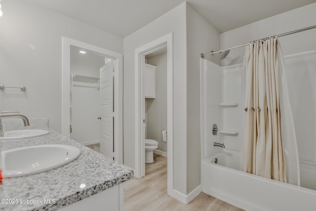 2933 Abbeville Ave, Wolfforth, TX 79382 - bathroom with double vanity, shower / bathtub combination with curtain, and wood finished floors