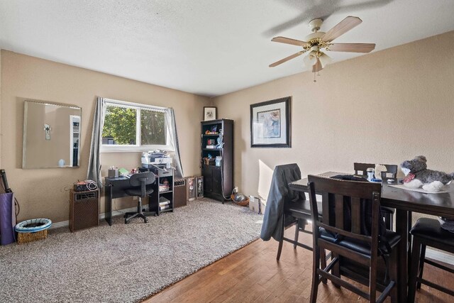 office space with a textured ceiling, wood-type flooring, and ceiling fan