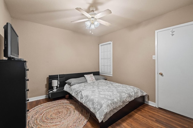 bedroom featuring ceiling fan and dark hardwood / wood-style flooring