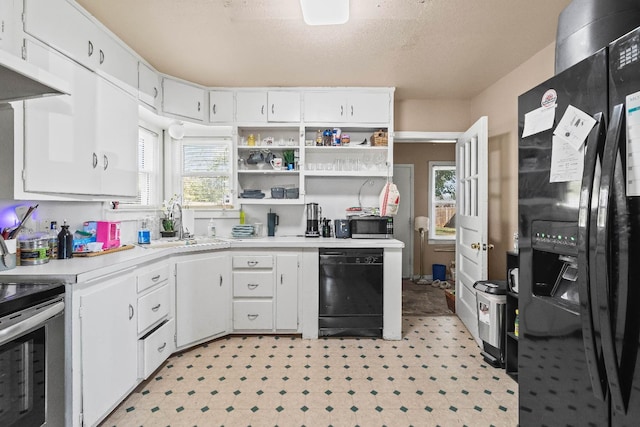 kitchen with white cabinetry, plenty of natural light, and black appliances