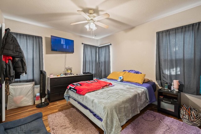 bedroom featuring hardwood / wood-style flooring and ceiling fan