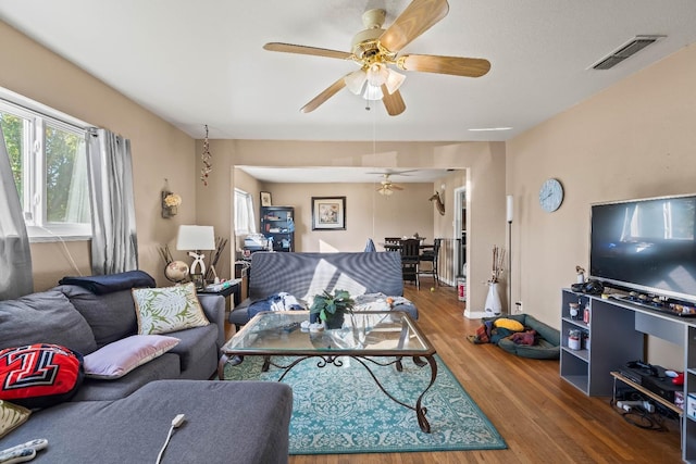 living room featuring hardwood / wood-style floors and ceiling fan