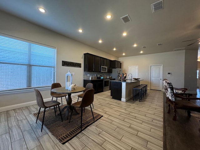 dining room with sink and ceiling fan