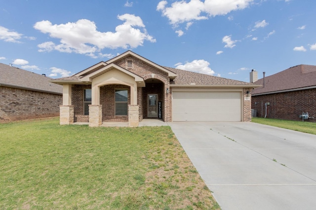 view of front facade with a garage and a front lawn